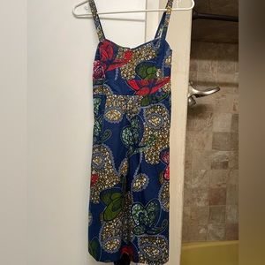 Never worn without tags dress with tie-back keyhole back. Beautiful multicolored